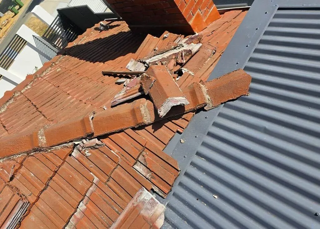 Cracked tiles and failing ridge mortar on a Perth roof