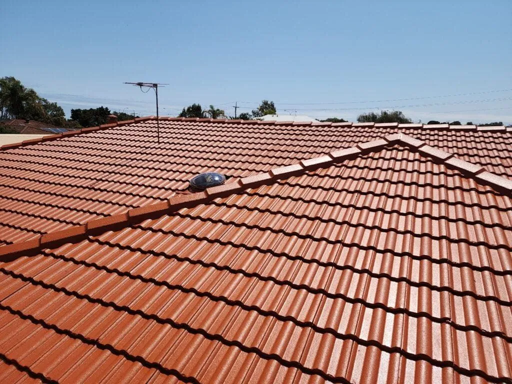 Ridge capping running along the peak of a red tile roof in Perth