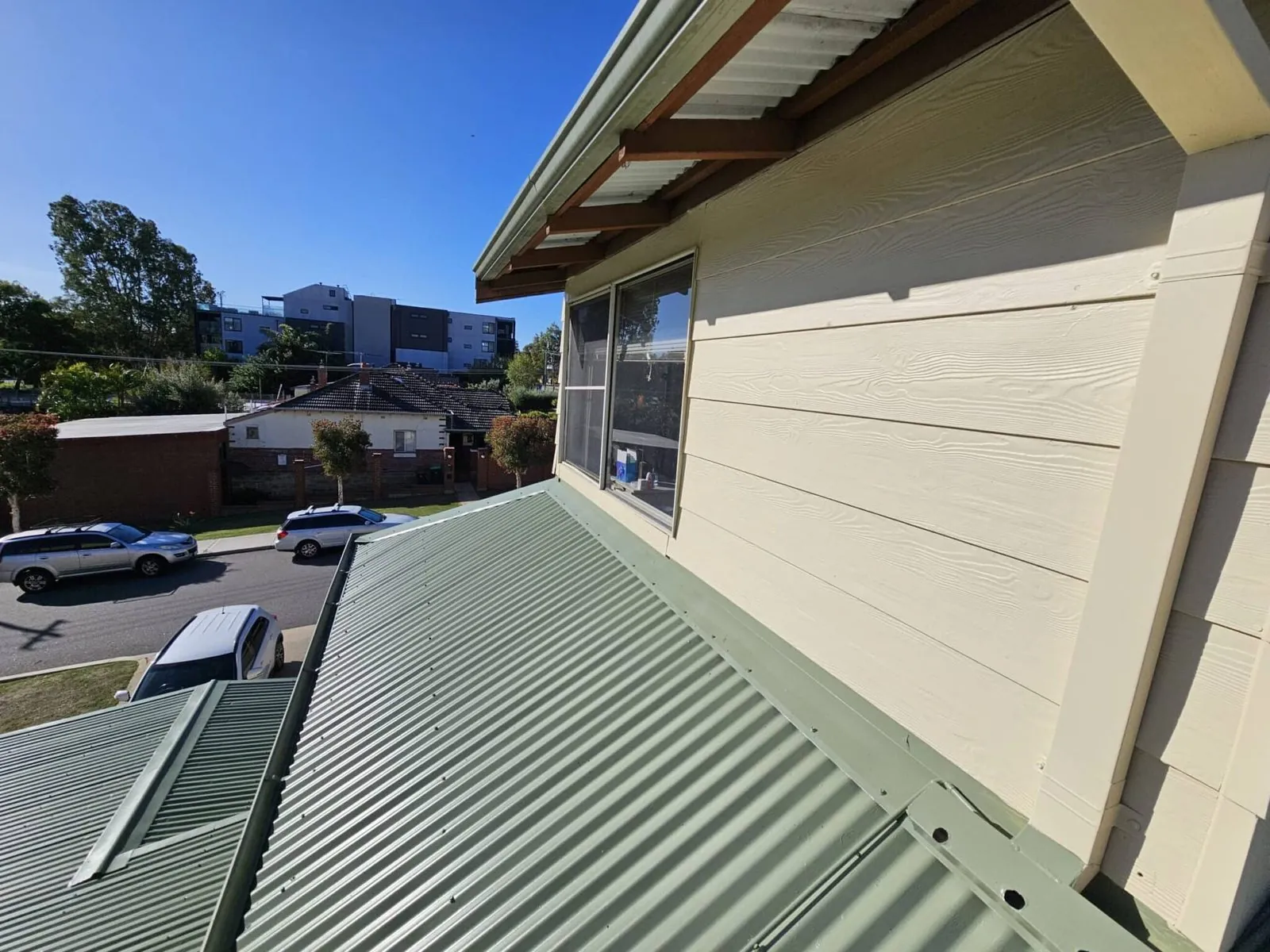 New Colorbond roof sheeting running into the wall of an extended Perth home