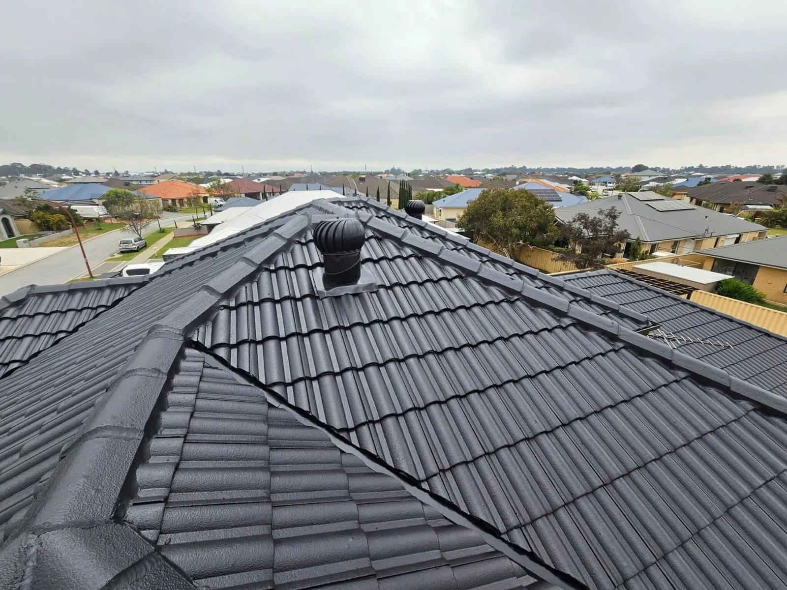 Tile roof restoration in progress on a Perth home