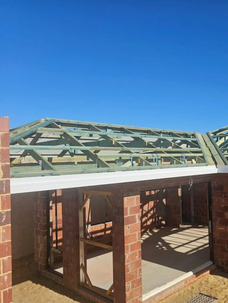 Roof frame and new fascia line above the brickwork of a home