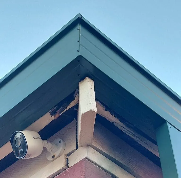 Rotten timber exposed behind a metal gutter on a Perth home