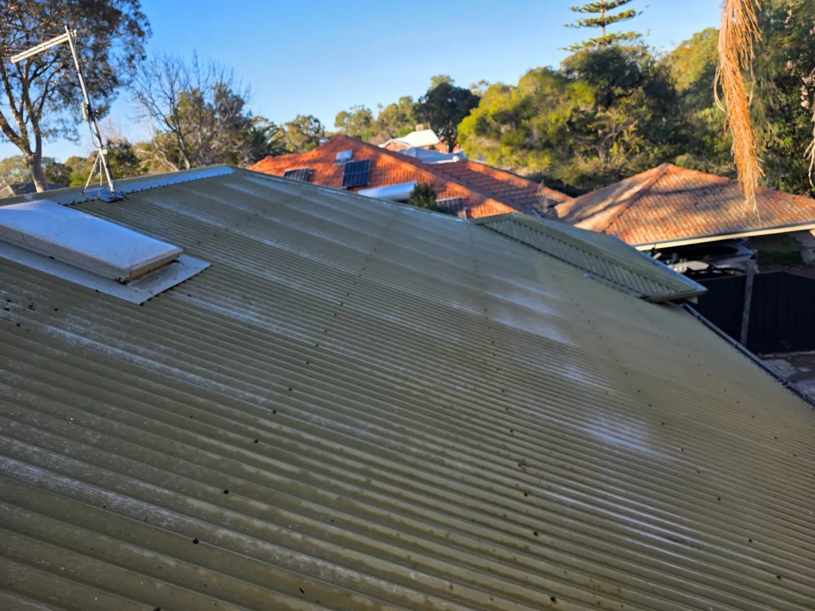 Weathered Colorbond roof in Floreat before painting, the original coating faded and patchy across the sheeting