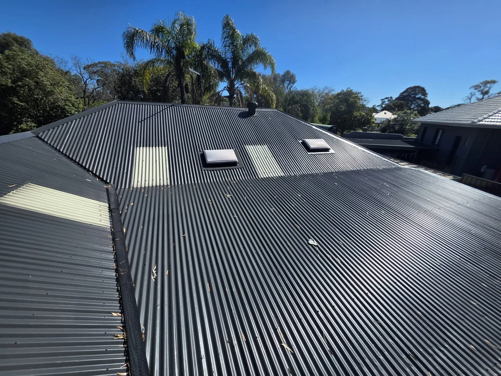 Finished Colorbond roof coated in Monument, the corrugated sheeting running clean to the ridge